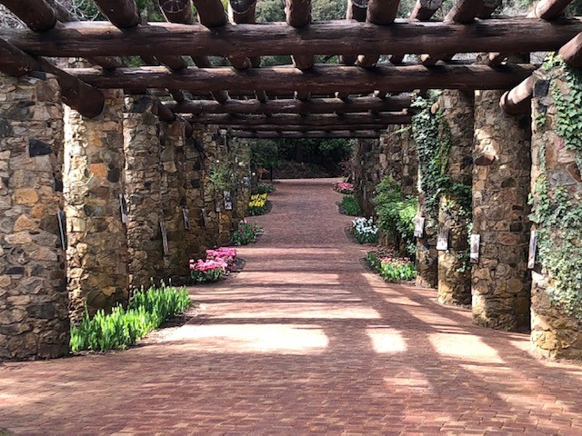 Araluen Botanical Park Pergola made in the 1930s with granite and jarrah pillars with flowers planted one side Araluen Botanical Park Pergola made in the 1930s with granite and jarrah pillars with flowers planted one side