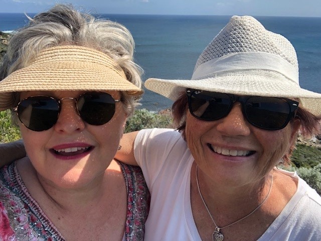A picture of Deb and Colleen whale watching with hats on and smiling. A picture of Deb and Colleen whale watching with hats on and smiling.